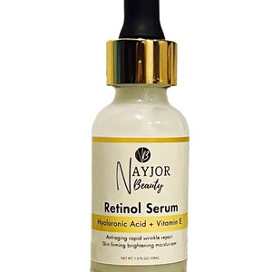 May include: A white glass bottle of Nayjor Beauty Retinol Serum with a black dropper and gold-colored collar. The label includes text: Retinol Serum, Hyaluronic Acid + Vitamin E, and Net Wt. 1.0 fl oz (30ml).