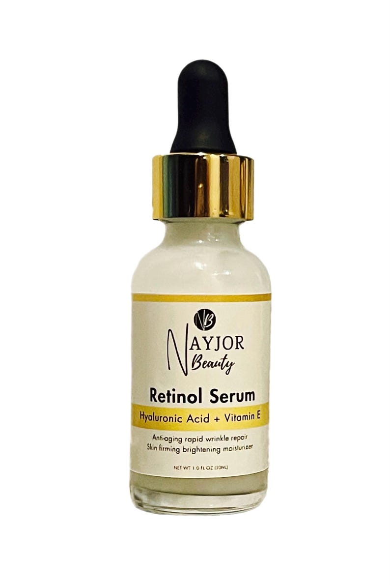 May include: A white glass bottle of Nayjor Beauty Retinol Serum with a black dropper and gold-colored collar. The label includes text: Retinol Serum, Hyaluronic Acid + Vitamin E, and Net Wt. 1.0 fl oz (30ml).