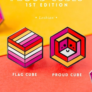 May include: Two enamel pins shaped like cubes with a lesbian pride flag design. One pin is a simple representation of the flag, while the other has a stylized face with a smile. The text "LGBTQ+ LAPEL PIN SERIES" and "PROUD CUBES 1ST EDITION" is at the top of the image. The text "Lesbian" is below the pins. The text "FLAG CUBE" and "PROUD CUBE" is below the pins. The text "Proud Zebra" and "www.proudzebra.com" is at the bottom of the image.