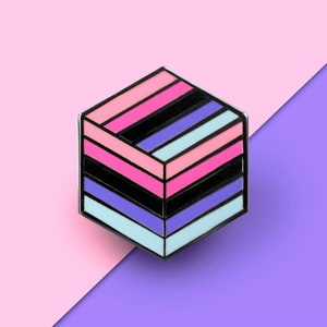 May include: A hexagonal pin with a layered design in shades of pink, blue, and black. The pin is on a pink and purple background.