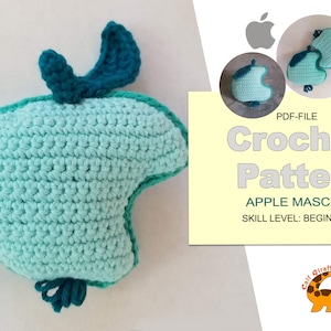 May include: Crochet pattern PDF file for a beginner level apple mascot. The image shows a teal and light blue crocheted apple with a green stem and leaf. The text on the image reads "PDF-FILE Crochet Pattern APPLE MASCOT SKILL LEVEL: BEGINNER".