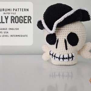 May include: A crocheted amigurumi Jolly Roger skull wearing a black and white pirate hat. The pattern is available in a PDF file. The pattern is written in English using US crochet terms. The skill level is intermediate.