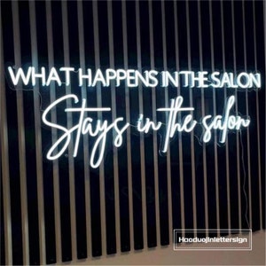 May include: White neon sign with the text "What happens in the salon stays in the salon".