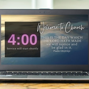 May include: A laptop screen displaying a welcome message for church service, with a countdown timer showing 4:00. The message reads "Welcome to Church" and includes a Bible verse: "This is the day which the Lord hath made, we will rejoice and be glad in it. Psalm 118:24 kjv."