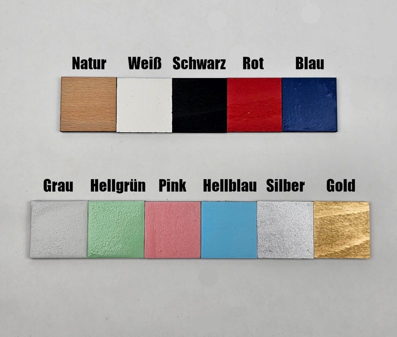 May include: A color chart with 10 different wood samples painted in various colors, including natural wood, white, black, red, blue, gray, light green, pink, light blue, silver, and gold.