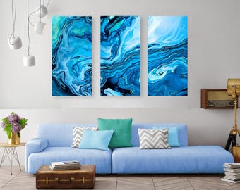 May include: A triptych wall art set featuring three vertical panels with an abstract fluid acrylic pour design in shades of deep navy, bright cerulean, turquoise, and white, creating swirling marble-like patterns across the canvas surfaces.