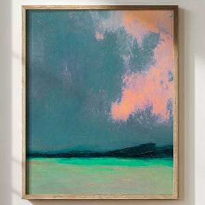 Large vertical abstract coastal wall art print featuring moody teal blue skies, soft blush pink cloud textures, deep navy horizon lines, and luminous turquoise water. The oversized framed artwork hangs in a modern neutral interior and has a dreamy atmospheric seascape feel with painterly textures and calming ocean-inspired tones. Ideal for modern coastal homes, luxury interiors, serene bedrooms, spa-inspired spaces, boutique Airbnbs, and contemporary gallery walls.