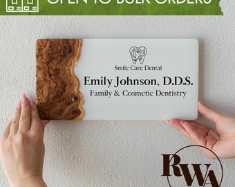 May include: A rectangular sign featuring a white acrylic surface on the right and a natural wood burl edge on the left. The text reads Smile Care Dental, Emily Johnson, D.D.S., and Family & Cosmetic Dentistry, with a tooth icon above the text.