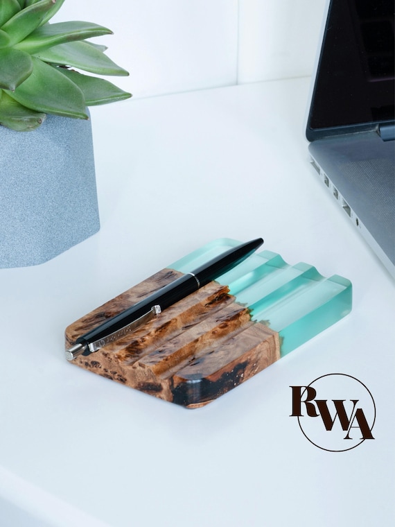 Handcrafted resin-and-wood pen tray with engraved elements — the kind of desk piece that looks expensive and intentional, not like an afterthought.