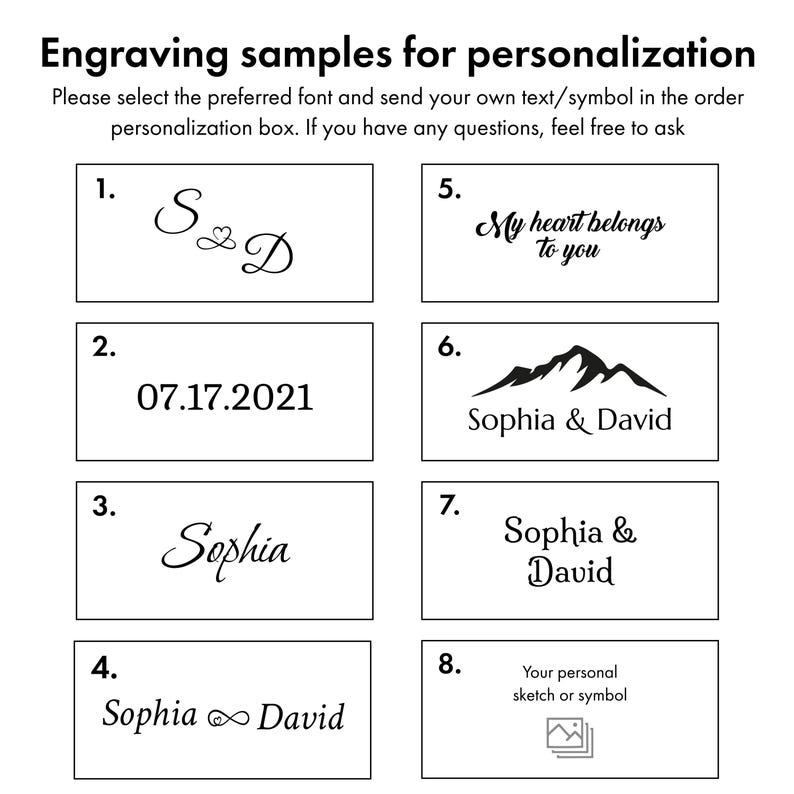 May include: Image showcasing engraving samples for personalization. The image displays various text and symbol options, including initials, dates, names, and phrases like "My heart belongs to you." It also includes a mountain graphic and a space for a personal sketch or symbol.
