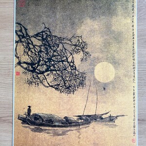 May include: An Asian-inspired print depicting a moonlit scene with boats on the water. A full moon shines in the sky, with a tree branch in the foreground. The print has a gold and black color scheme.