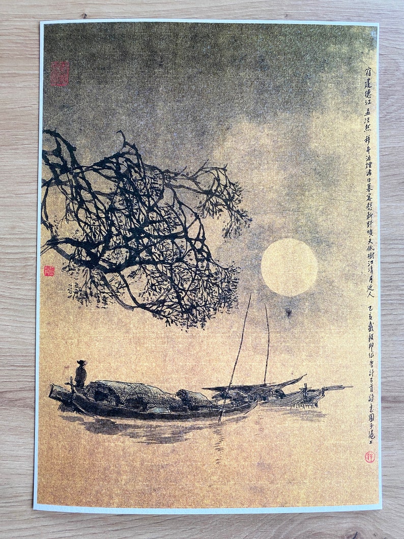 May include: An Asian-inspired print depicting a moonlit scene with boats on the water. A full moon shines in the sky, with a tree branch in the foreground. The print has a gold and black color scheme.