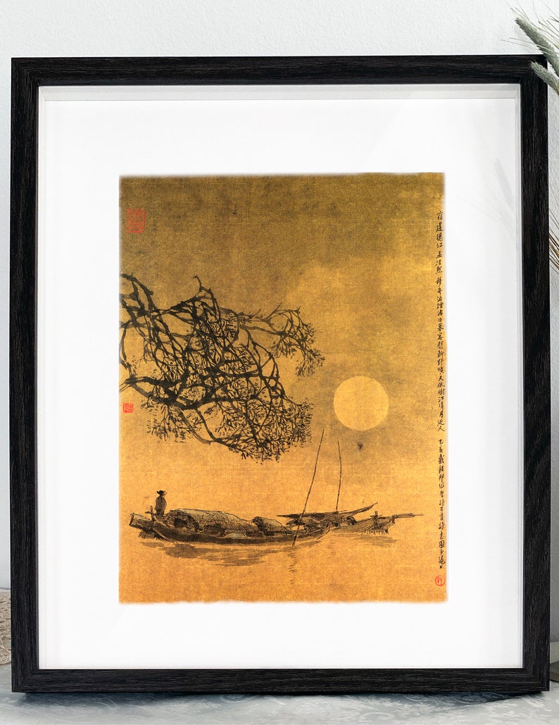 May include: Framed art print depicting a serene moonlit scene with a boat on the water. The artwork features a full moon, a tree branch, and a boat with a person. The print is in a black frame with a white mat.
