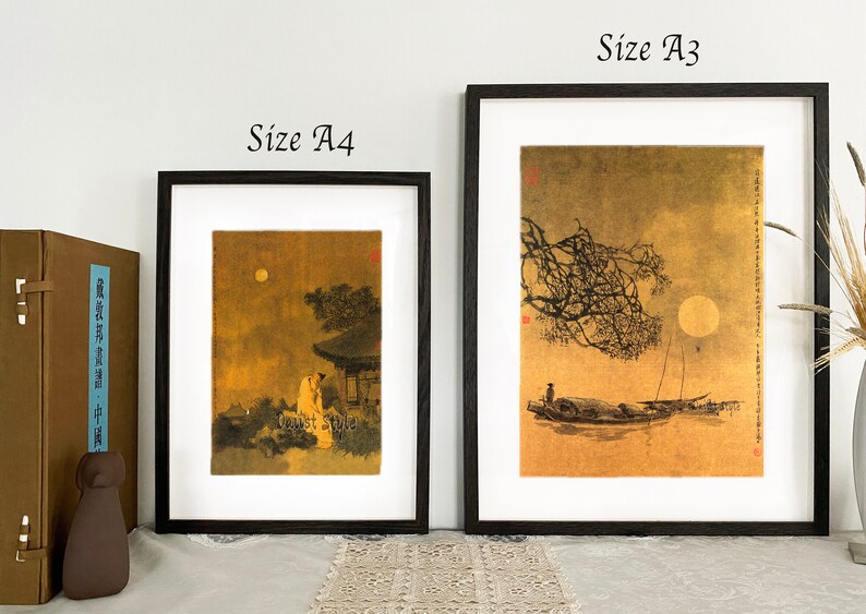 May include: Two framed art prints with black frames, labeled "Size A4" and "Size A3". The prints depict traditional Asian scenes with figures, trees, and a full moon. The artwork has a gold and brown color palette.
