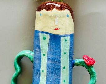 Handmade ceramic vase with quirky handles and face