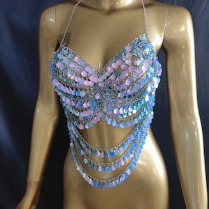 May include: A halter-style body chain top constructed from silver-toned metal links and iridescent, light-reflecting circular sequins. The garment features a structured bodice design with multiple draped chain layers extending downward to the waist.