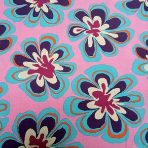 May include: A repeating pattern of large, stylized flowers in shades of purple, teal, orange, and cream against a pink background. The floral design has a retro, psychedelic aesthetic, suitable for fabric or wallpaper.