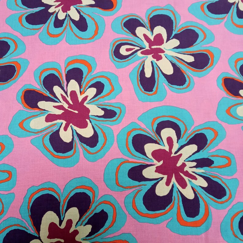 May include: A repeating pattern of large, stylized flowers in shades of purple, teal, orange, and cream against a pink background. The floral design has a retro, psychedelic aesthetic, suitable for fabric or wallpaper.