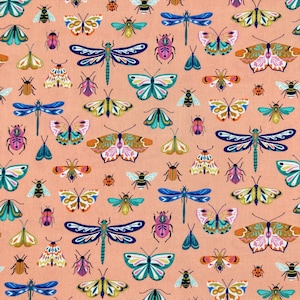 May include: A peach-coloured fabric with a repeating pattern of colourful butterflies, dragonflies, and ladybugs. The pattern is whimsical and playful, perfect for a variety of crafting projects.