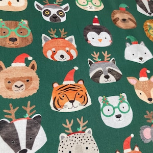 May include: A green fabric with a repeating pattern of various animals wearing Christmas hats and reindeer antlers. The animals include a penguin, a raccoon, a tiger, a red panda, a badger, a deer, a llama, a sloth, a lemur, a polar bear, and a fox.