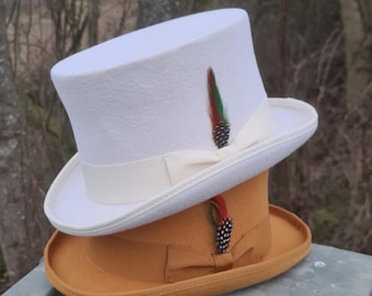 May include: A white top hat with a cream colored band and a brown top hat with a brown band. Both hats have a feather accent.