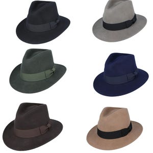 May include: Six fedora hats in different colors: black, gray, green, navy blue, brown, and beige. Each hat has a black ribbon around the crown.