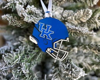 May include: Blue and white Christmas ornament shaped like a football helmet with the letters "UK" on the side.