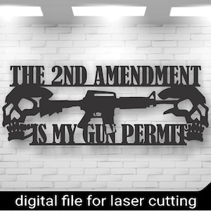 Puede incluir: Un letrero de metal negro con el texto "The 2nd Amendment is my gun permit" y una silueta de un rifle con calaveras a cada lado.