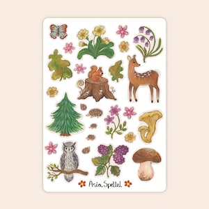 May include: A sticker sheet with watercolour illustrations of woodland flora and fauna. Depicts a deer, squirrel, owl, mushrooms, flowers, and a butterfly. The text "Asia Spettel" is at the bottom.