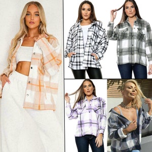May include: Four women are wearing different plaid shirts. The shirts are in various colours, including black, white, grey, orange, and purple. All of the shirts are long-sleeved and have a button-down front.
