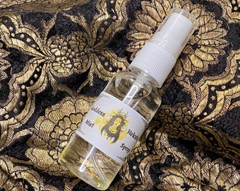 May include: A clear glass bottle with a white spray top. The bottle is labeled "Goddess Mist Hekate Spray".