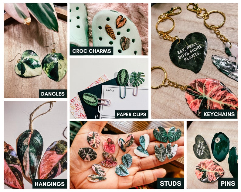 May include: Assortment of handmade jewelry featuring colorful leaf designs.  The jewelry includes earrings, keychains, hanging ornaments, paper clips, pins, and shoe charms.  The text "Eat. Pray. Buys More Plants." is featured on one of the keychains.