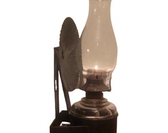 Wall mounted oil lamp with reflector outlet