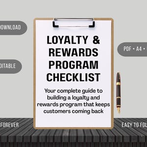 May include: A wooden clipboard holding a white sheet of paper with the black printed text: LOYALTY & REWARDS PROGRAM CHECKLIST. Your complete guide to building a loyalty and rewards program that keeps customers coming back. A black and gold fountain pen.
