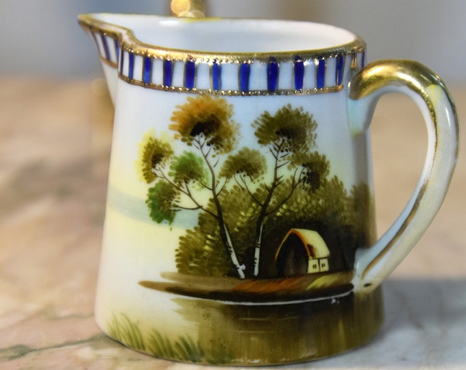 Small hand painted creamer with gold trim and exquisite details. Handpainted in Japan midcentury EUC! From a New England Estate