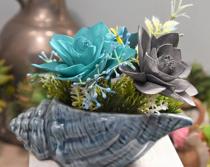 Blue seashell planter filled with three sustainable Sola wood wildflowers - beach theme, ocean theme, fish theme, lake theme