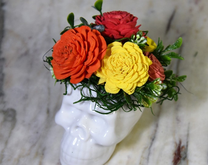 Día de los Muertos, Day of the Dead, small white ceramic sugar style skull, with dyed double marigold style Sola wood flowers