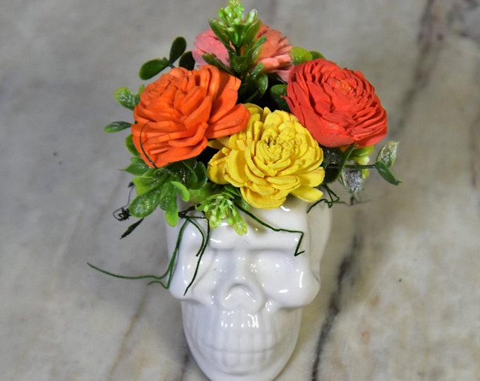 Día de los Muertos, Day of the Dead, small white ceramic sugar style skull, with dyed double marigold style Sola wood flowers