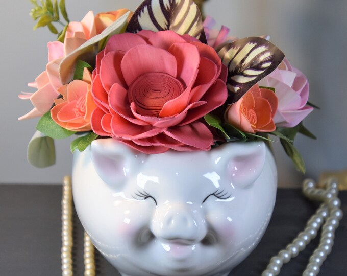 Adorable large ceramic smiling pig planter filled with Sola wood flowers in shades of pink peach and white-sustainable and forever