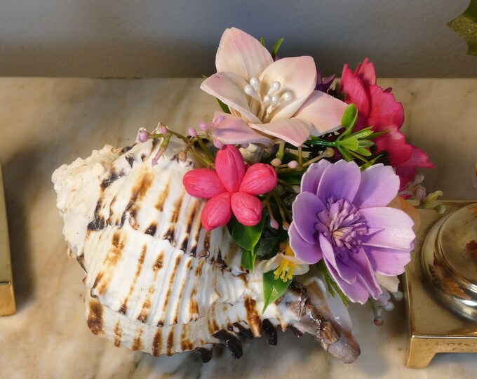 5" Black murex shell with arrangement of small 1 -1 1/2 inch Sola wood flowers