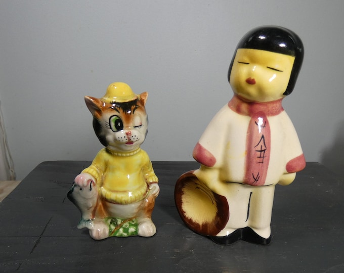 Two vintage or antique Japan porcelain figurines, salt shaker cat with fish and man with hat