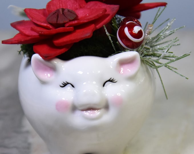 We all need a holiday smiling pig! Small adorable small ceramic smiling pig planter filled with Sola wood poinsettias - never needs watering