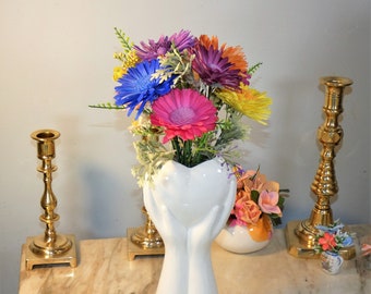 Hand holding a bouquet of bright daisies. 9" tall vase w/7 airbrushed Sola wood daisies-last forever-great gift or pop of color for any room