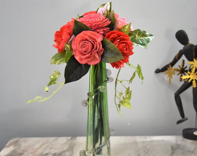 Unique green handmade vase filled with a stunning sustainable Sola wood flower bouquet in dark coral and coral pink