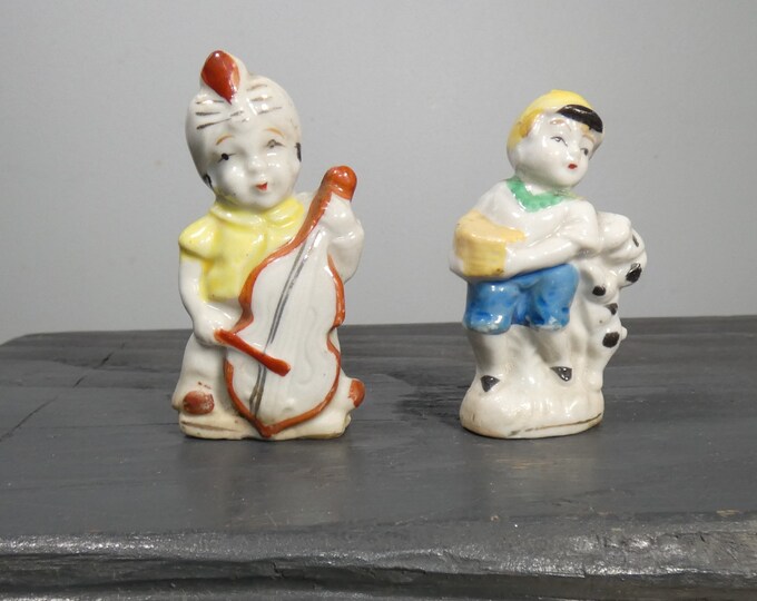 Two vintage or antique Japan porcelain figurines, boy with dog, musician with upright base