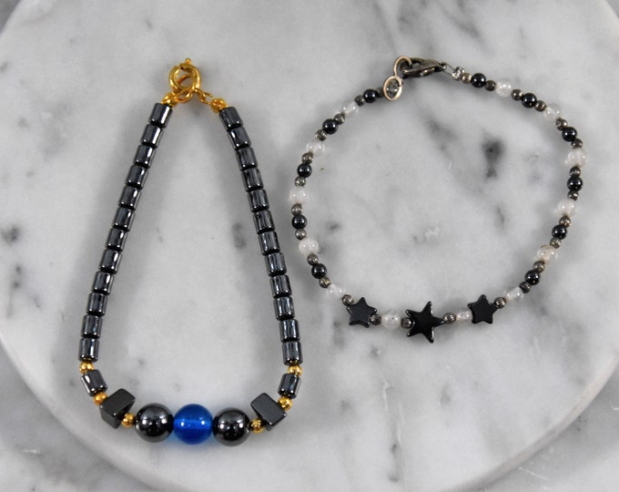 Two hemetite jewelry bracelets - one gold-tone findings and one silver-tone findings - from a New England estate