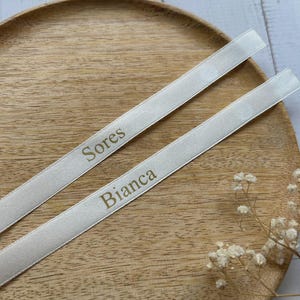 Custom satin ribbon, with the names printed in gold lettering.