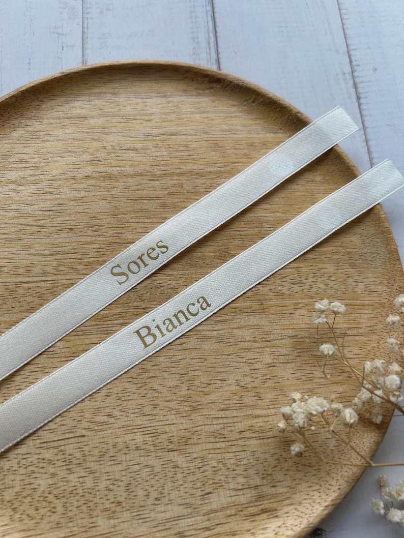 Custom satin ribbon, with the names printed in gold lettering.