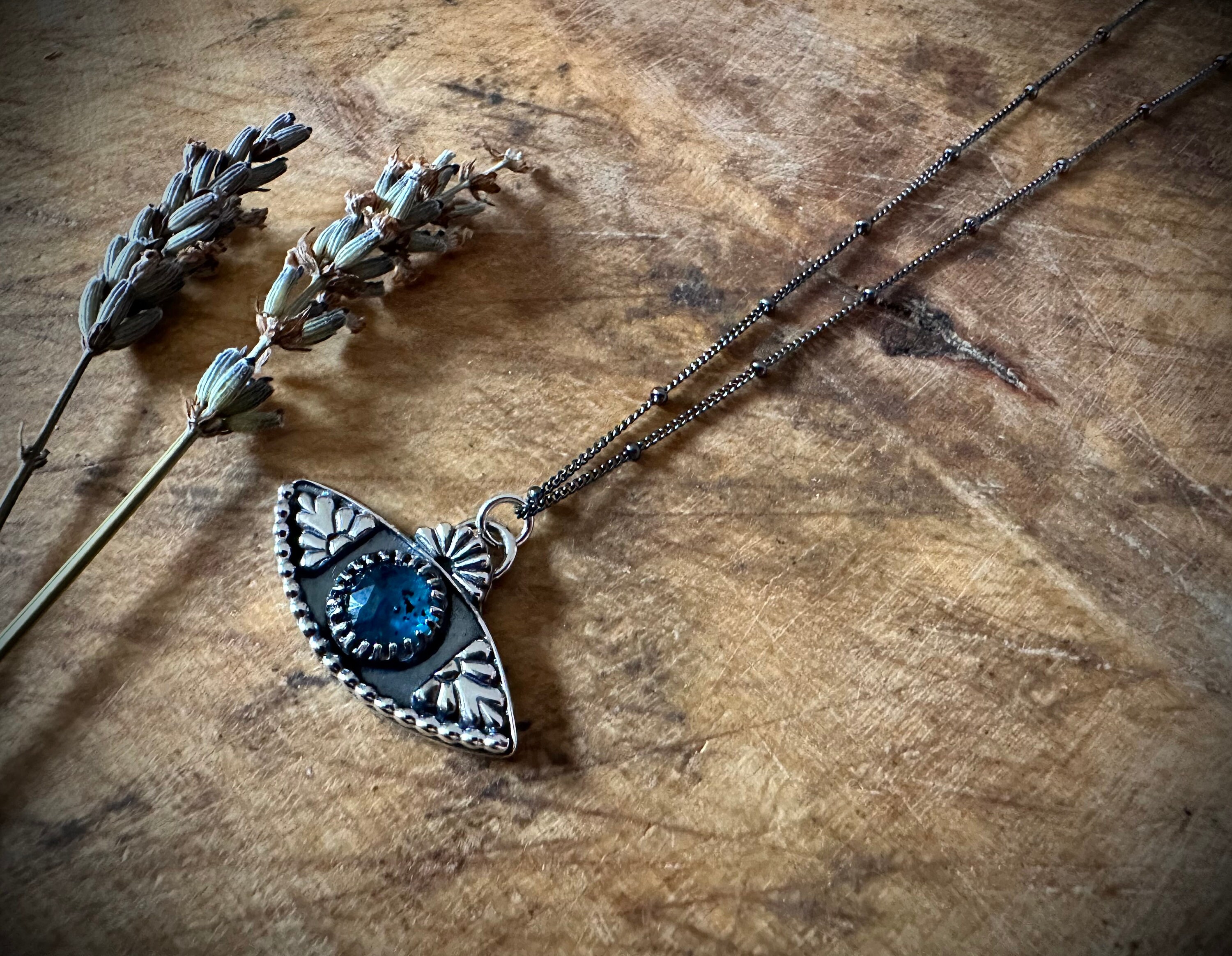 Evil Eye Protection Pendant Sterling silver with a teal Kyanite. Hallmarked. Chain length 18inch with a blackened finish and beaded detail