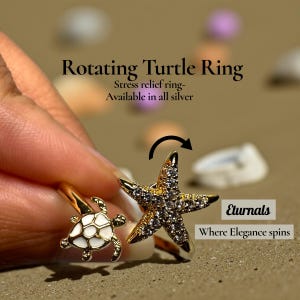May include: A gold-toned rotating ring with a starfish and turtle design. The ring features a white and gold turtle and a sparkling starfish. Text on the image reads "Rotating Turtle Ring" and "Eternals Where Elegance spins."